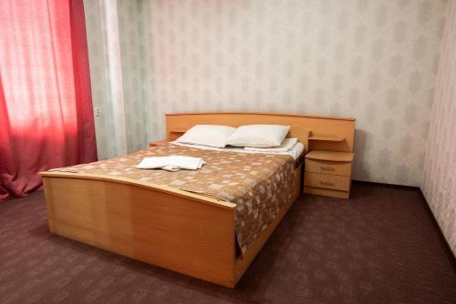 a bedroom with a bed with two towels on it at Гостиница Караганда in Karagandy