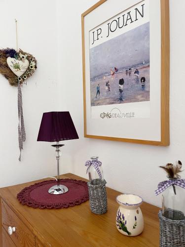 a table with a lamp and a picture on the wall at Haus Edeltraut in Bad Mitterndorf