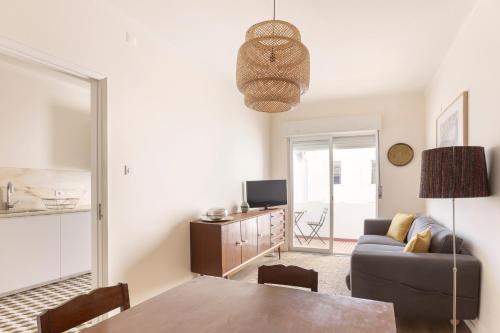 a living room with a couch and a table at Casa ao Cubo in Olhão