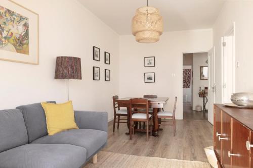 a living room with a couch and a table at Casa ao Cubo in Olhão