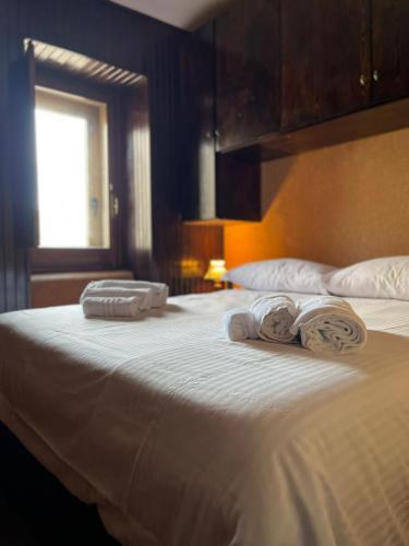 two towels on a bed in a hotel room at Casa Belvedere Sant’Anna in Rivisondoli