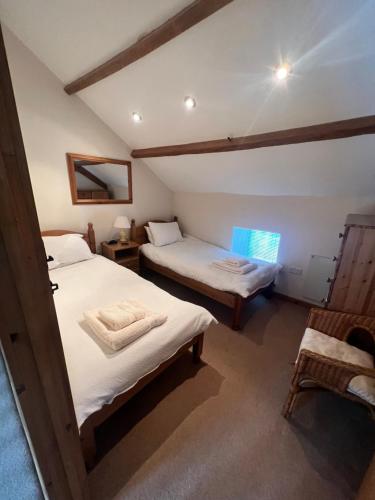 a room with two beds in a house at Prospect Farm Cottages in Allerston