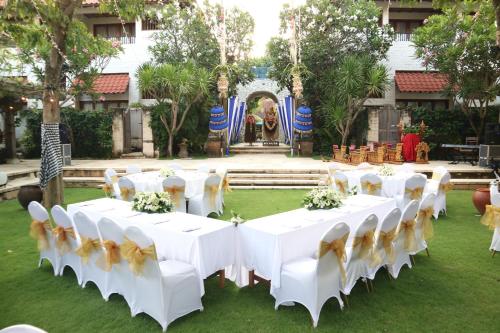 a white table topped with white chairs and flowers at Sudamala Resort, Sanur, Bali in Sanur