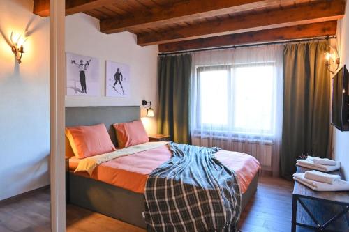 1 dormitorio con cama y ventana en Marand Villas, en Bansko