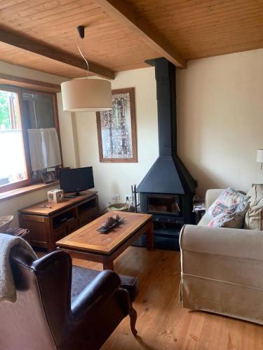 a living room with a couch and a fireplace at Vistas Sant Climent Taüll in Taüll