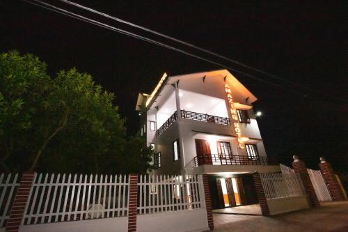 a white house with a white fence at night at Amazing Hotel, Trương Pháp, Quang Phú, Đồng Hới in Dong Hoi