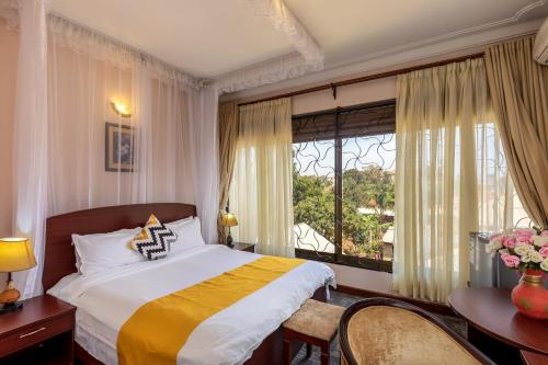 Krevet ili kreveti u jedinici u okviru objekta Entebbe Traveller's Hotel
