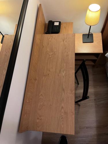 a room with a desk and a phone on a table at Hotel Umbria in Perugia