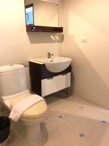 a bathroom with a white toilet and a sink at Laemdin Hotel in Koh Samui 