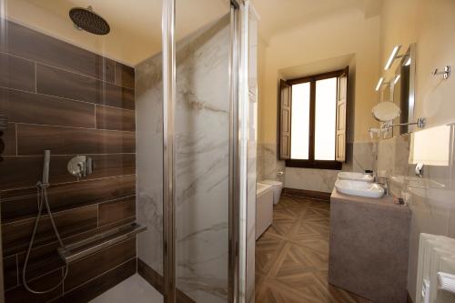 y baño con ducha y lavamanos. en Palazzo Martellini Residenza d'epoca, en Florencia
