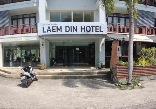 a motorcycle parked in front of a hotel at Laemdin Hotel in Koh Samui 