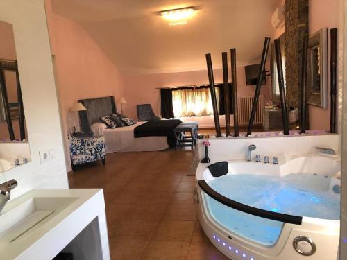 a bathroom with a tub in the middle of a room at Hospedería Casa Martell in Daroca