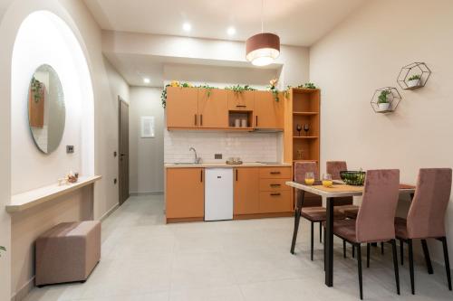a kitchen and dining room with a table and chairs at Bella Vacanza Studios in Zakynthos Town