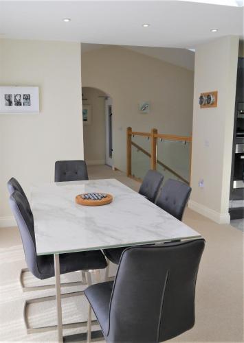 a conference room with a table and chairs at Driftwood in Kippford