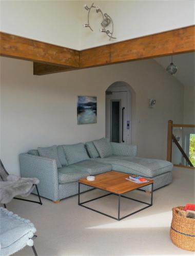a living room with a couch and a coffee table at Driftwood in Kippford
