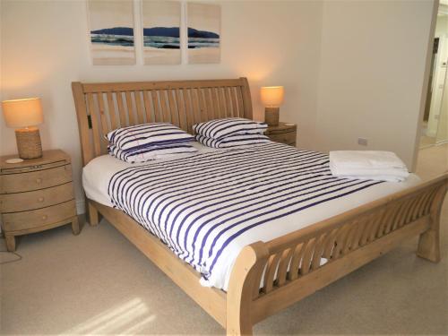 a bed with two pillows on it in a bedroom at Driftwood in Kippford