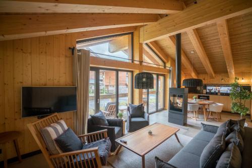 a living room with a couch and a table at Chalet One Jasná in Demanovska Dolina