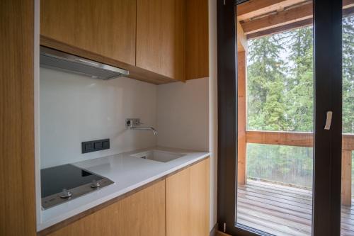a kitchen with a sink and a window at Chalet One Jasná in Demanovska Dolina