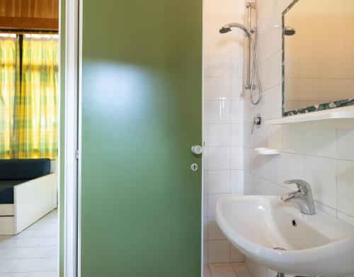 a bathroom with a sink and a mirror at Residence Mare Pineta in Casal Borsetti