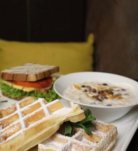a table with two plates of food and a sandwich at Yavir in Poltava