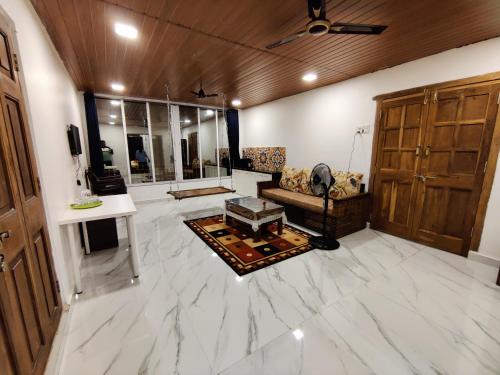 a living room with a large white marble floor at WhiteHouse Homestay by Oxystays Hospitality in Alibaug