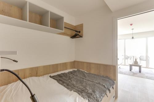 a bedroom with a bed and a large window at Evancy La Marina Boulogne-sur-Mer in Boulogne-sur-Mer