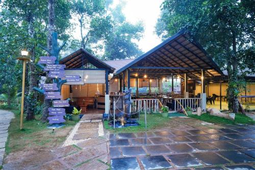 a house with a street sign in front of it at Kuruva Island Resort And Spa - By KABINI BREEZE in Mananthavady