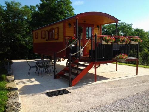 a tiny house with a slide and a table at La Roulotte de Bourgogne in Brianny