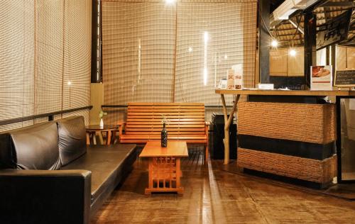 a living room with a couch and a table at Kuruva Island Resort And Spa - By KABINI BREEZE in Mananthavady