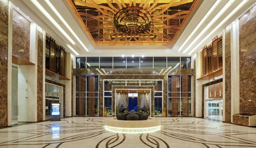 a lobby with a fountain in the middle of a building at Sayaji Kolhapur in Kolhapur