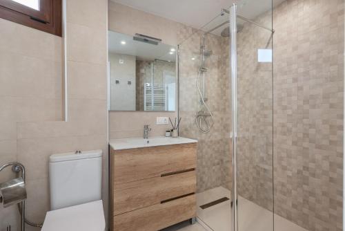 a bathroom with a shower and a toilet and a sink at BLUE LAGOON in Port d'Alcudia