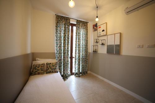 a room with a window with curtains and a couch at Casa Ercoli Abbadia in Abbadia di Montepulciano
