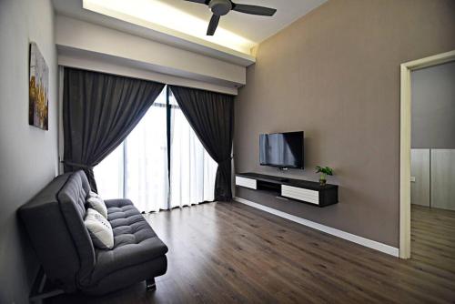 a living room with a couch and a television at Instay Costa Mahkota Next to Mahkota Parade in Malacca