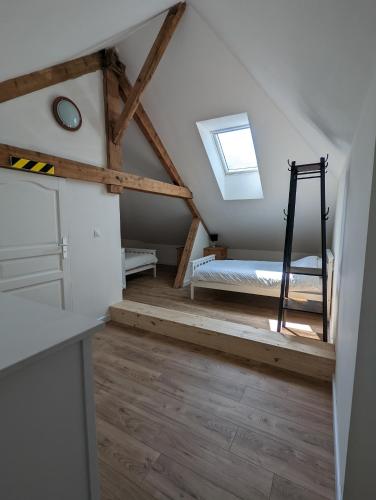 a attic room with a bed and a window at MSK65 Pyrenees Accommodation Sarrancolin in Sarrancolin