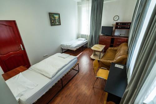 a hospital room with a bed and a couch at Apartamentai Klaipeda Inn in Klaipėda