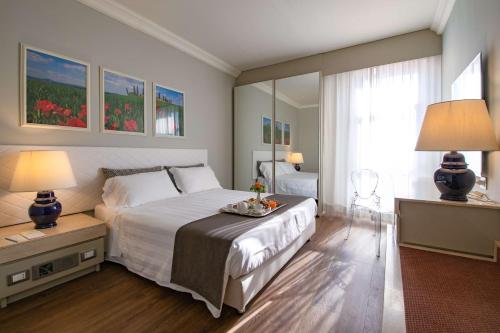 a bedroom with a large white bed and a window at Etrusco Arezzo Hotel - Sure Hotel Collection by Best Western in Arezzo