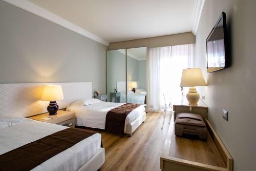 A bed or beds in a room at Etrusco Arezzo Hotel - Sure Hotel Collection by Best Western