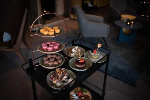 a table with several plates of food on it at Hotel Schweizerhof Lenzerheide in Lenzerheide