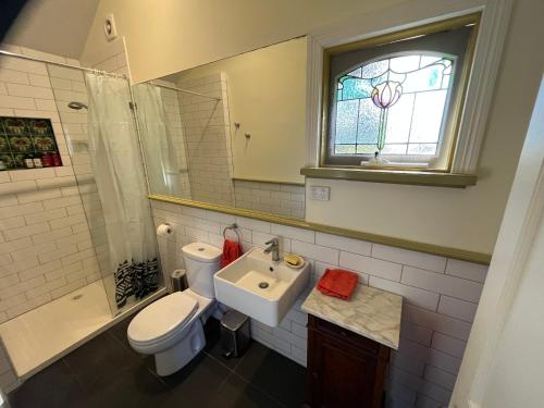 a bathroom with a toilet and a sink and a shower at The Dairy Cottage - Lake Lorne - Drysdale in Drysdale