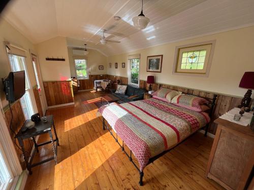 um quarto com uma cama e uma sala de estar em The Dairy Cottage - Lake Lorne - Drysdale em Drysdale