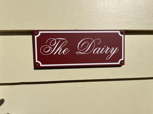 a sign on a wall that says the dairy at The Dairy Cottage - Lake Lorne - Drysdale in Drysdale