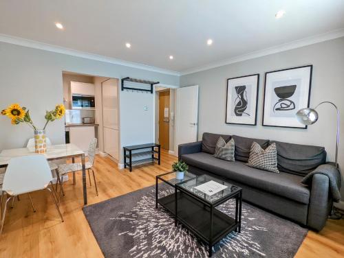 a living room with a couch and a table at Saffron Court by Wycombe Apartments - Apt 08 in High Wycombe