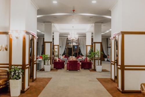 a banquet hall with tables and chairs and a chandelier at Afra Oghuz Mountain Resort Hotel in Oğuz