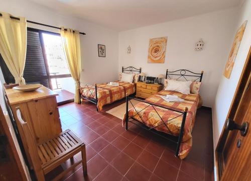 a bedroom with two beds and a window at Carvoeiro Beach Algarve Portugal Praia do Carvoeiro in Carvoeiro