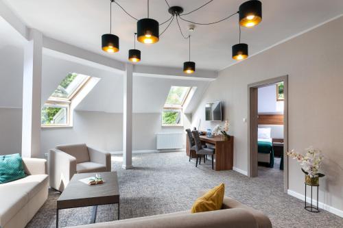 a living room with a couch and a table at Apartamenty i pokoje Montana in Kudowa-Zdrój