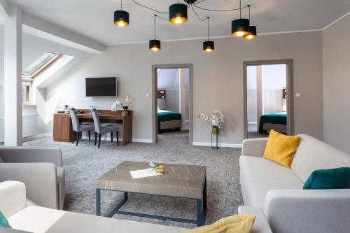 a living room with a couch and a table at Apartamenty i pokoje Montana in Kudowa-Zdrój