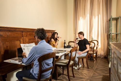 a group of people sitting around a table at Palazzo Martellini Residenza d'epoca in Florence