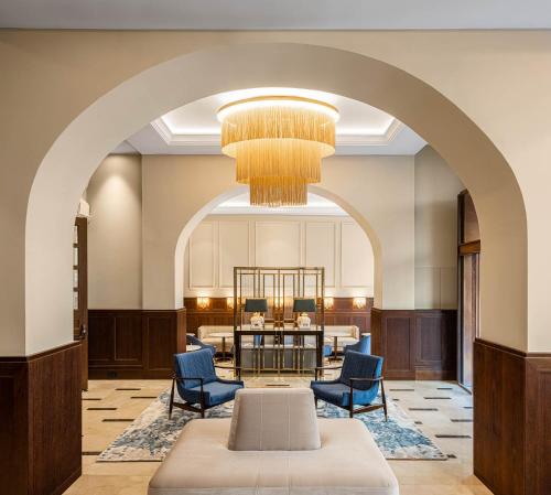 an archway in a lobby with chairs and a table at ICON Duplo Ribeira in Porto