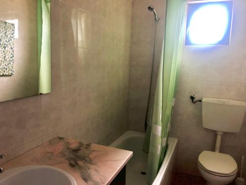 a bathroom with a sink and a toilet and a shower at Casa Valverde in Cartaxo