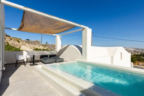 a villa with a swimming pool and a patio at SERAPIAS SUITES in Éxo Goniá